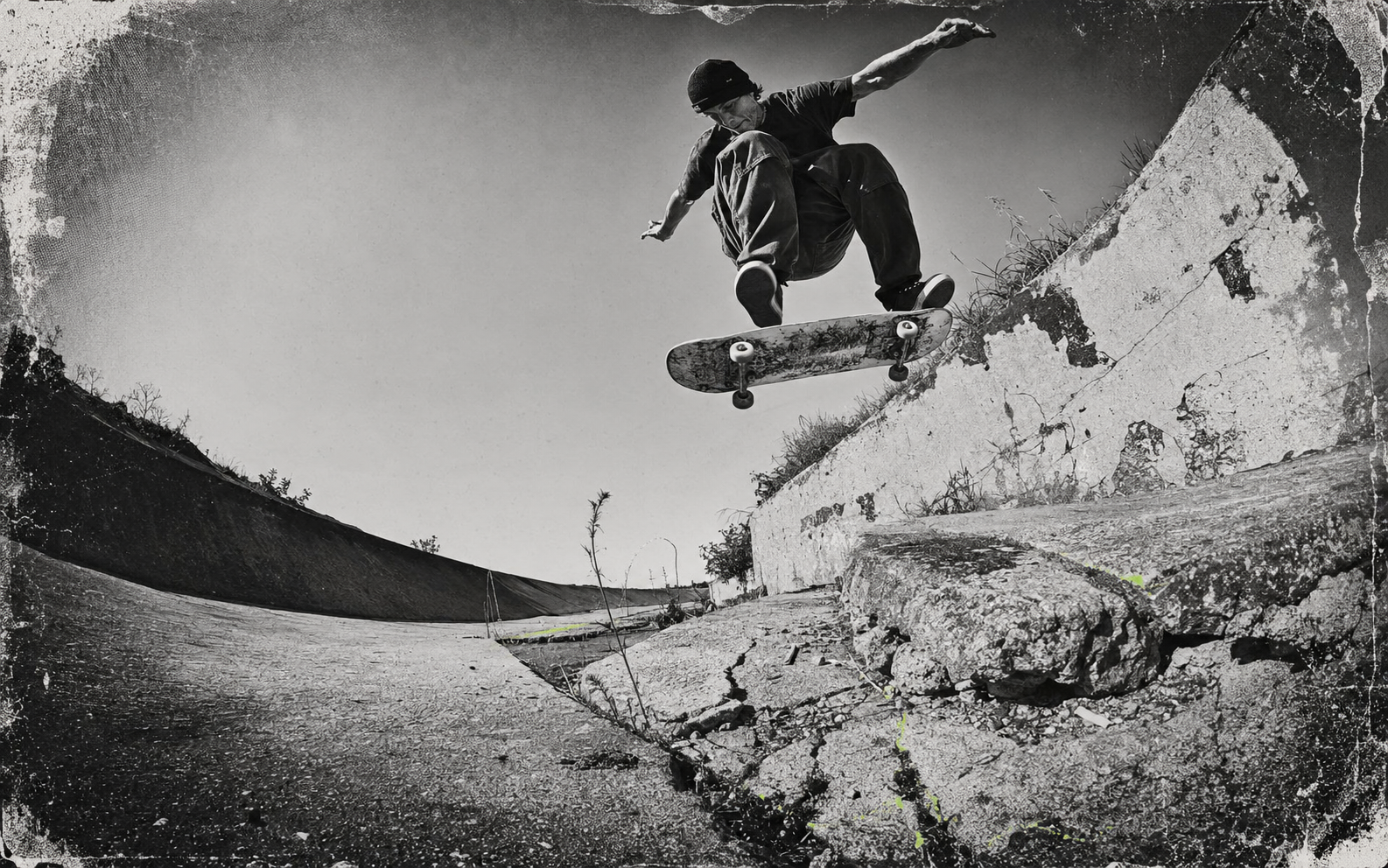 Skater clearing a cracked concrete gap